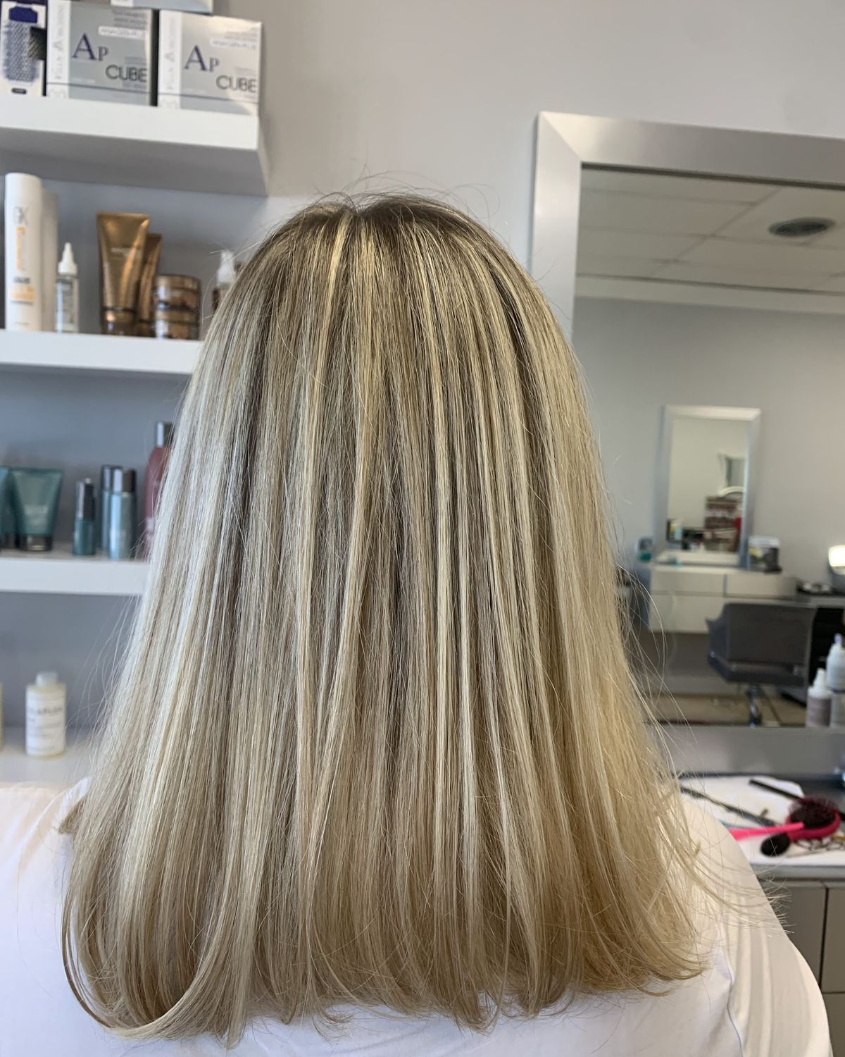 Platinum brightness blended through blonde at shoulder length — Toucheé Organic Salon, Juno Beach